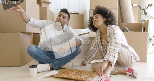 Image of Young couple eating pizza and chatting