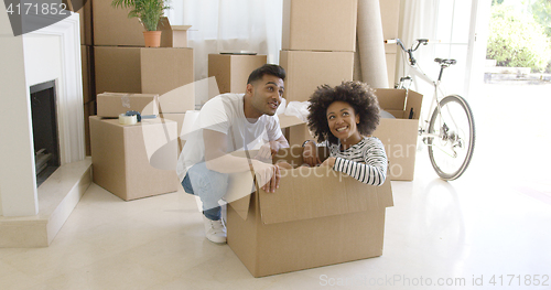 Image of Happy young couple moving house together