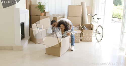 Image of Fun young woman inside a packing box