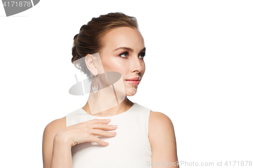 Image of smiling woman in white dress with pearl jewelry