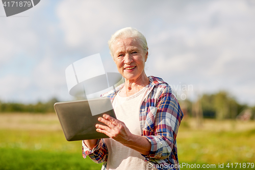 Image of senior woman with tablet pc computer at county