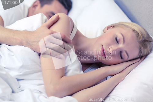 Image of happy couple sleeping in bed