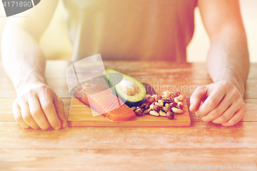 Image of close up of male hands with food rich in protein