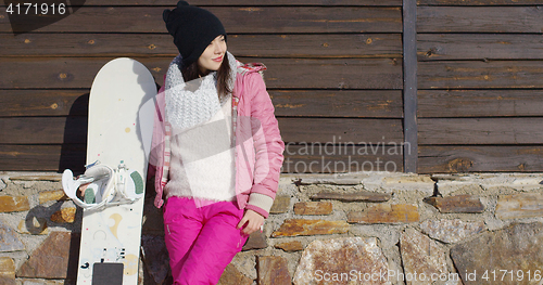 Image of Pretty young woman with snowboard