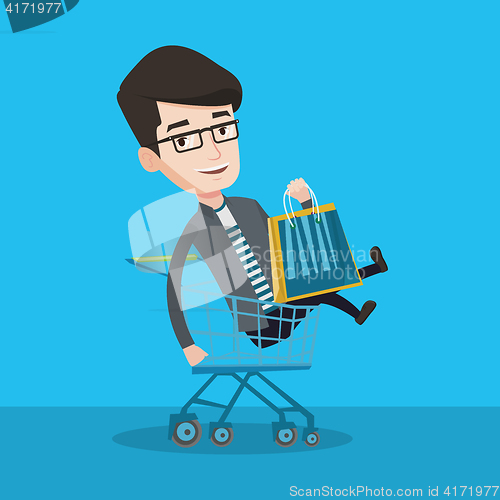 Image of Happy man riding by shopping trolley.