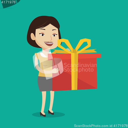 Image of Joyful caucasian woman holding box with gift.
