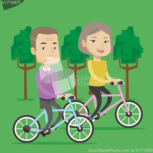 Image of Happy senior couple riding on bicycles in the park