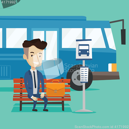 Image of Businessman waiting for bus at the bus stop.