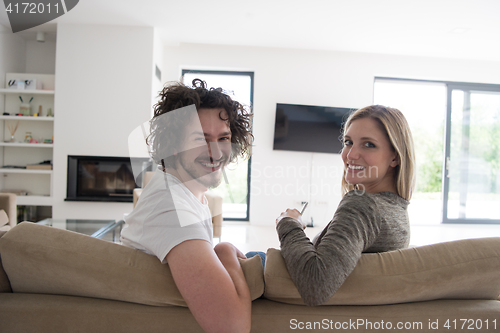 Image of Rear view of couple watching television