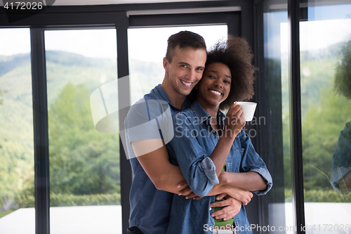 Image of romantic happy young couple relax at modern home indoors