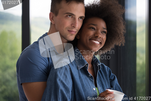 Image of romantic happy young couple relax at modern home indoors