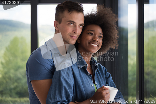 Image of romantic happy young couple relax at modern home indoors