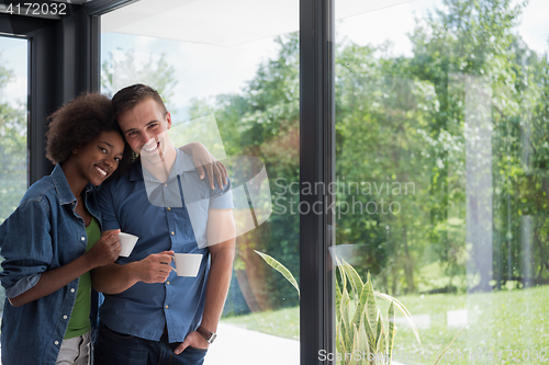 Image of romantic happy young couple relax at modern home indoors