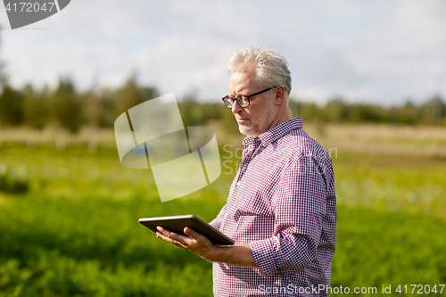 Image of senior man with tablet pc computer at county