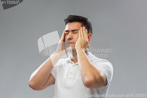 Image of unhappy man suffering from head ache