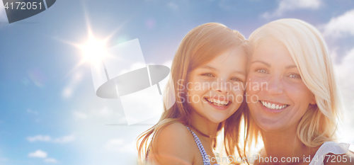 Image of happy mother and child girl over sun in blue sky