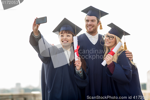 Image of students or bachelors taking selfie by smartphone