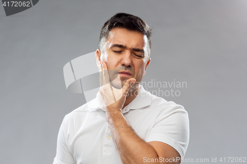 Image of unhappy man suffering toothache