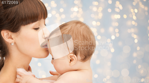 Image of happy mother kissing adorable baby