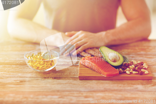 Image of close up of male hands with food rich in protein