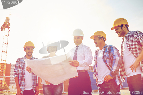 Image of group of builders and architects with blueprint
