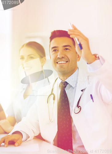 Image of group of happy doctors on conference at hospital