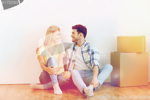 Image of couple with cardboard boxes moving to new home