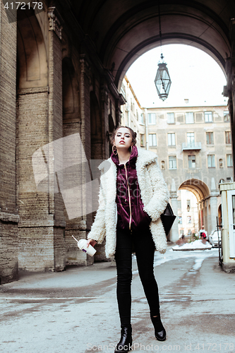 Image of young pretty stylish teenage girl outside on city street fancy f