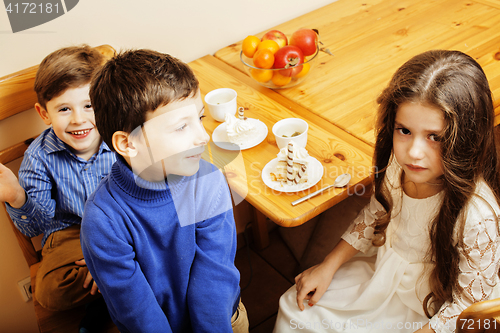 Image of little cute boys eating dessert on wooden kitchen. home interior. smiling adorable friendship together forever friends, lifestyle people concept