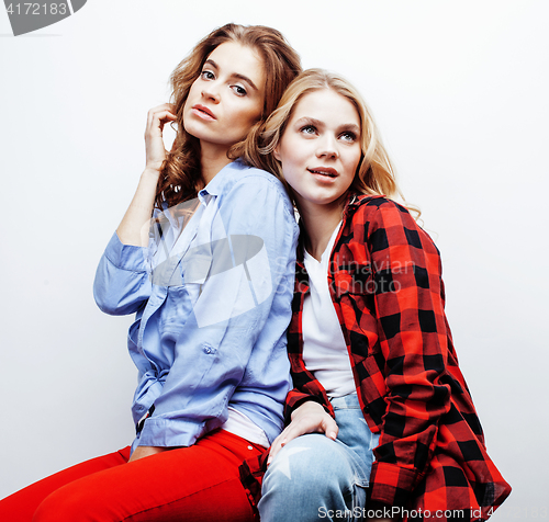 Image of two pretty blond woman having fun together on white background, mature mother and young teenage daughter, lifestyle people concept