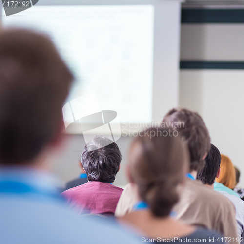 Image of Audience in lecture hall participating at business conference.