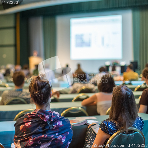 Image of Audience in lecture hall participating at business conference.