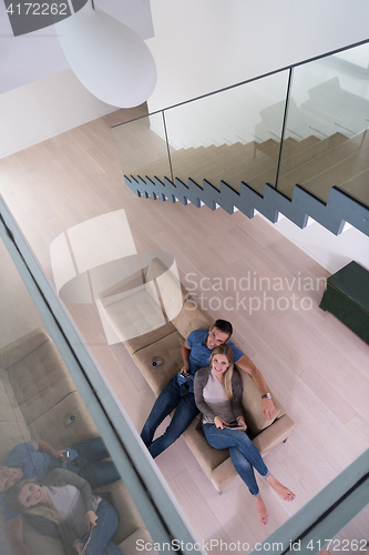 Image of youg couple in living room with tablet top view