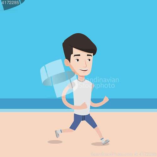 Image of Young sporty man jogging on the beach.