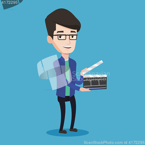 Image of Smiling man holding an open clapperboard.