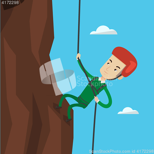 Image of Man climbing in mountains with rope.