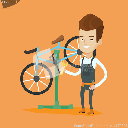 Image of Caucasian bicycle mechanic working in repair shop.