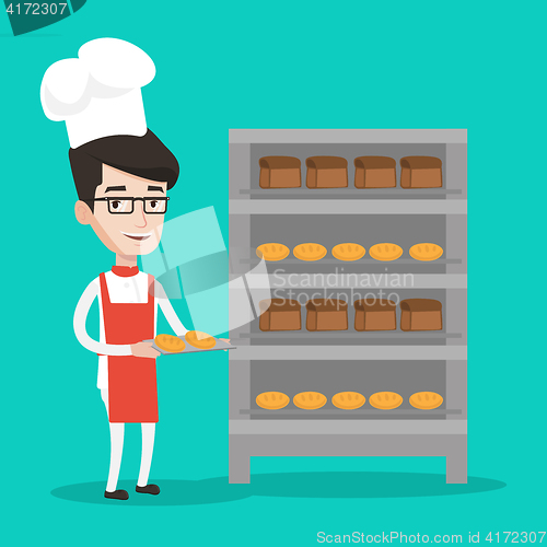 Image of Happy young male baker holding tray of bread.