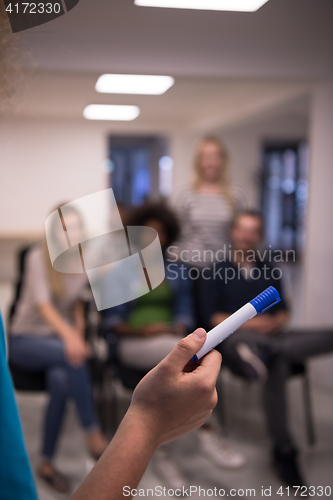 Image of close up of teacher hand with marker