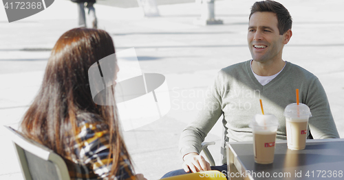 Image of Young couple enjoying takeaway coffee