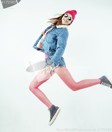 Image of lifestyle people concept: happy smiling hipster girl jumping on white background isolated