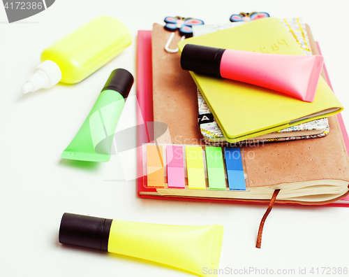 Image of business, education and technology concept - close up of notebook, paper stickers, glasses, pencil different stuff on white background