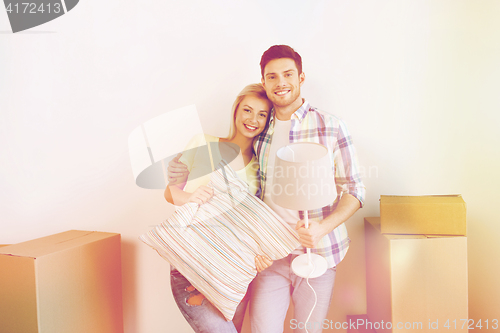 Image of happy couple with stuff moving to new home