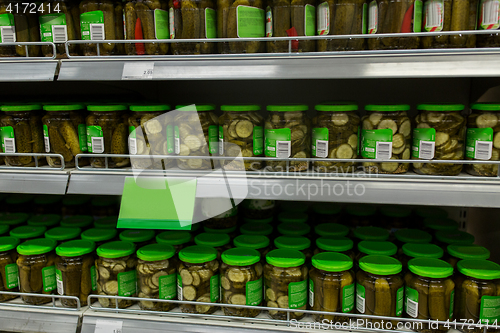 Image of jars of pickles on grocery or supermarket shelves