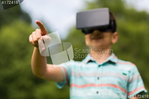 Image of boy with virtual reality headset outdoors
