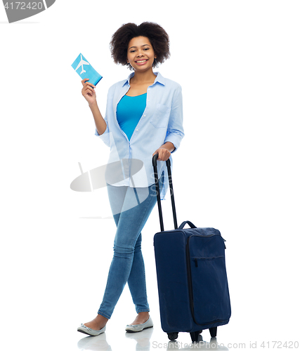 Image of happy woman with airplane ticket and travel bag