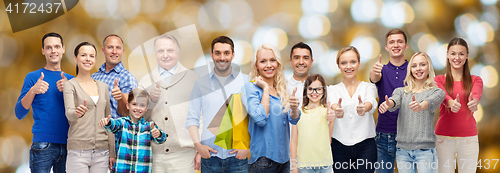 Image of happy people with shopping bags showing thumbs up