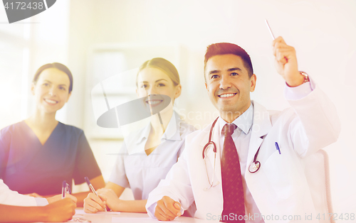 Image of group of happy doctors on conference at hospital