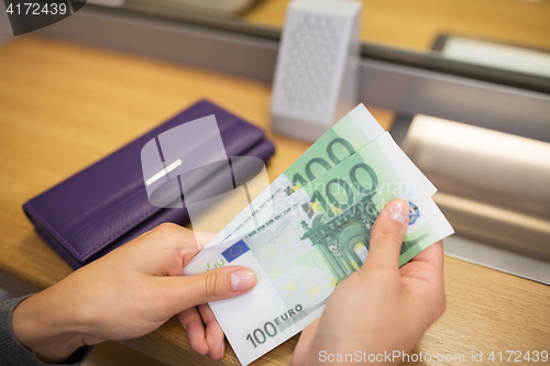 Image of hands with money at bank or currency exchanger