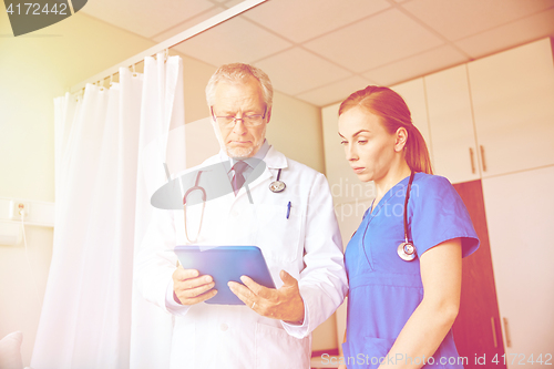 Image of senior doctor and nurse with tablet pc at hospital